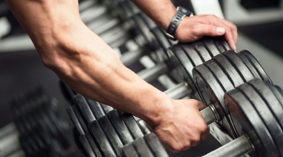 Arm picking up dumbbell